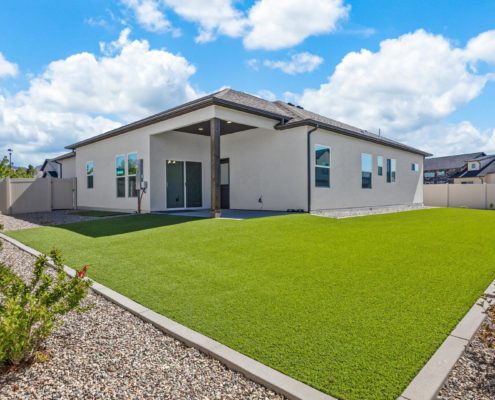 Backyard 3111 Clyde Ct. Grand Junction CO backyard with artificial turf and professional landscaping with vinyl fence