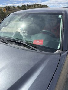 Toyota Tacoma showing the red sleeve holding our vehicle registration card with our Colorado State Park pass inside it