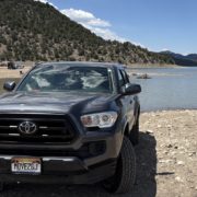 Our Toyota Tacoma parked on the beach at Ridgway State Park Reservoir