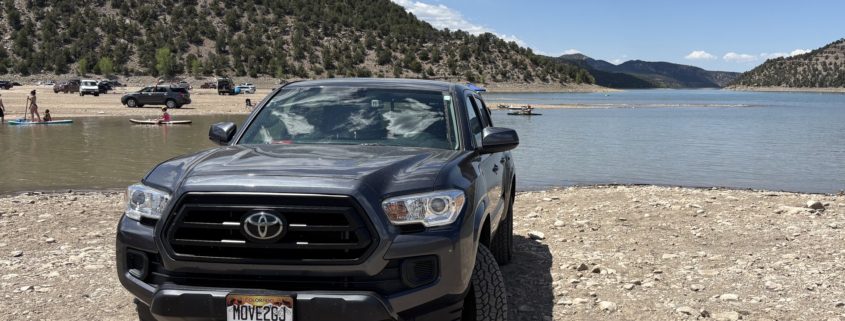 Our Toyota Tacoma parked on the beach at Ridgway State Park Reservoir