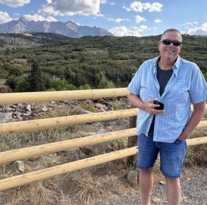 Paul Aspelin standing at the Double RL Ranch fence overlooking the San Juan Mountains
