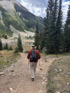 Paul Aspelin hiking to Crater Lake near Maroon Bells Aspen area with Yeti water bottle sticking out of backpack