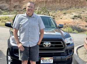 Paul Aspelin standing in front of his Toyota Tacoma, he's your Grand Junction Real Estate Guide