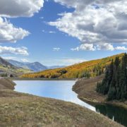 Fall Leaves in Crested Butte with mountain in the back and small lake in the foreground