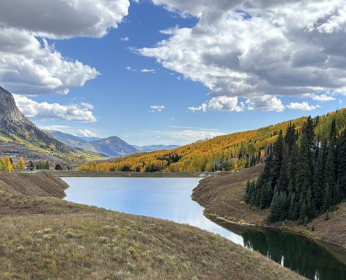 Fall Leaves in Crested Butte with mountain in the back and small lake in the foreground