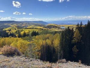 View from the Land o' Lakes trail overlook showing mountains, aspen leaves, and Indian Lake