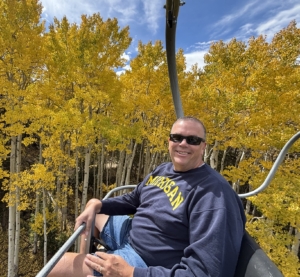 Paul Aspelin on the chairlift at Powderhorn showing the yellow aspen leaves