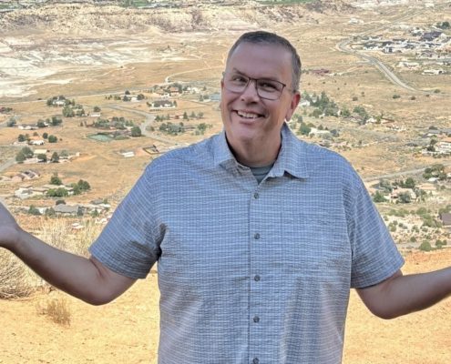 Paul Aspelin standing at the top of Serpents Trail overlooking Grand Junction