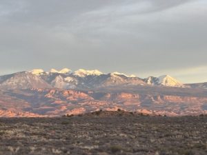 setting sun reflecting on the mountains in Arches National Park