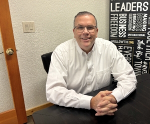 Paul Aspelin sitting at the conference table at the office