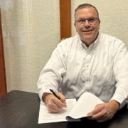 Paul Aspelin signing papers Paul Aspelin signing contracts at the office