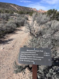 trailhead sign with miles for the hiking route options