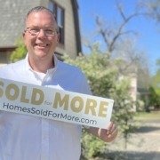 Paul Aspelin holding a Sold for More sign