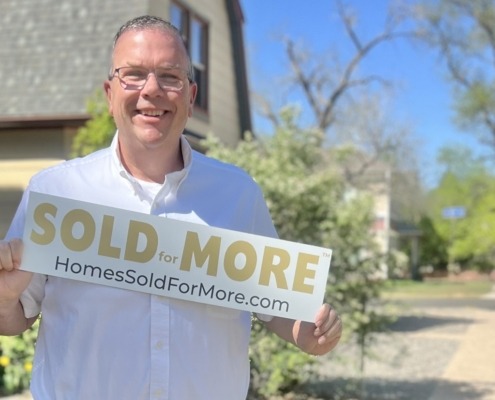Paul Aspelin holding a Sold for More sign