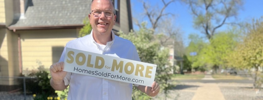 Paul Aspelin holding a Sold for More sign