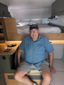 Paul sitting inside the Outpost 8.0 truck camper