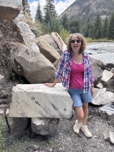 Michelle standing next to a chunk of marble by the Crystal River