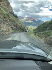 Toyota Tacoma driving on shelf road near Emerald Lake in Crested Butte