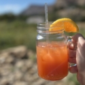 Megan doing Cheers with cocktail with Mount Garfield in the background