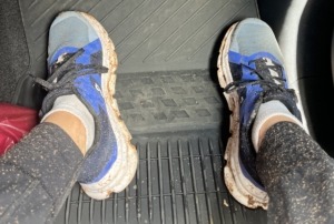 Megan's muddy shoes while she's sitting in the truck