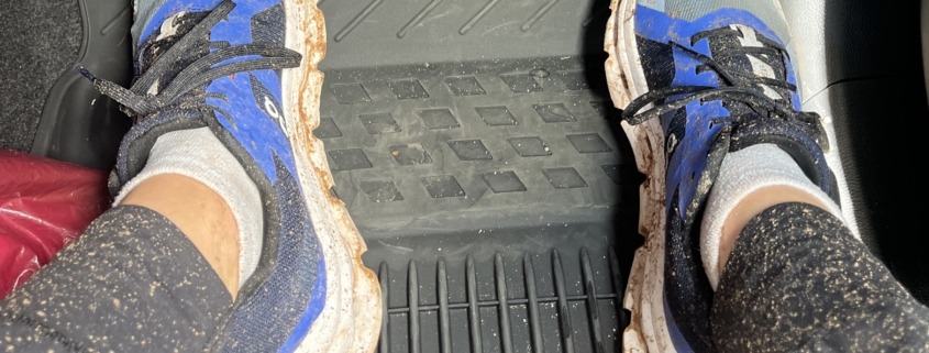 Megan's muddy shoes while she's sitting in the truck