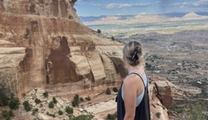Megan Jirele overlooking Grand Junction from the top of Serpents Trail in the Colorado National Monument