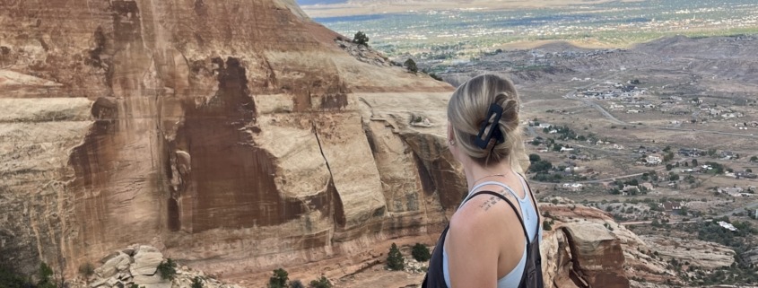 Megan Jirele overlooking Grand Junction from the top of Serpents Trail in the Colorado National Monument
