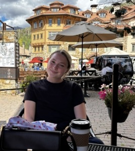Megan enjoying hot chocolate at a coffee shop in Mountain Village, CO