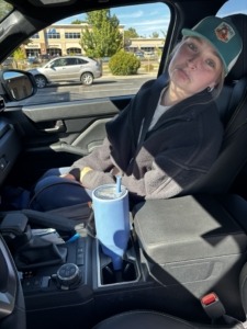 Megan with a sad face sitting in the car as we drive to the airport